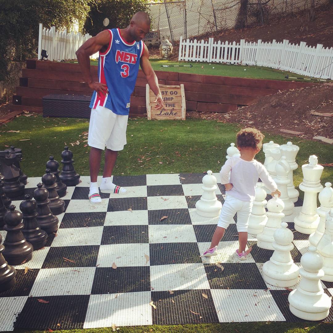 Troy Warwell and daughter playing chess