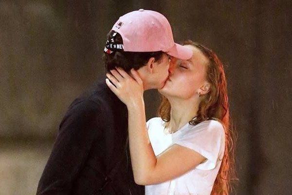 Timothee Chalamet and Lily-Rose kissing under the rain