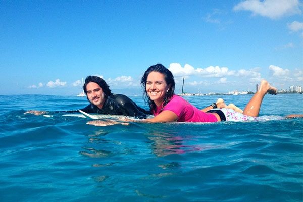 Tulsi Gabbard and Abraham Williams surfing 