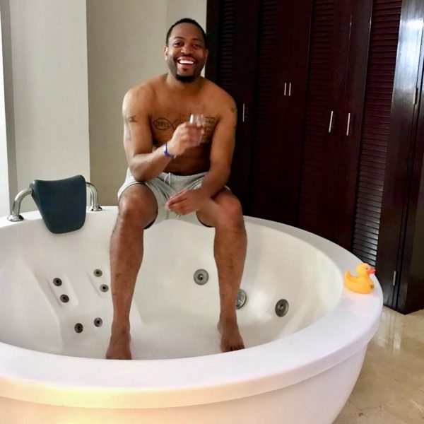 Amirah Vann's boyfriend Patrick Oyeku posing in a bathtub