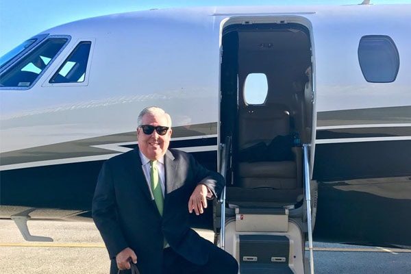 Lawyer John Morgan flaunting his lavish lifestyle in front of his private jet.