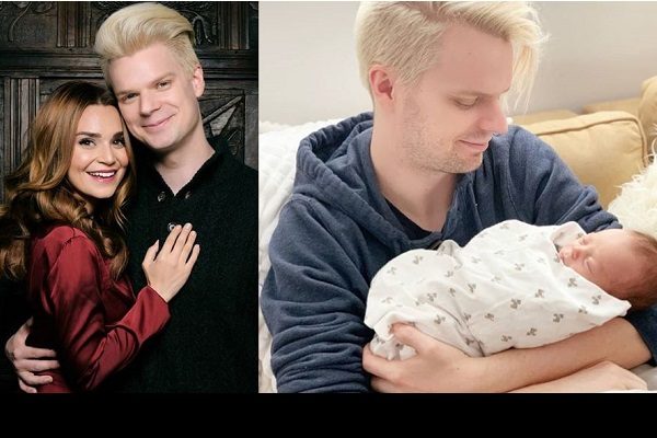 mike with his wife and holding his son